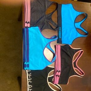 Set of five blue pink, black and white under Armour sports bras